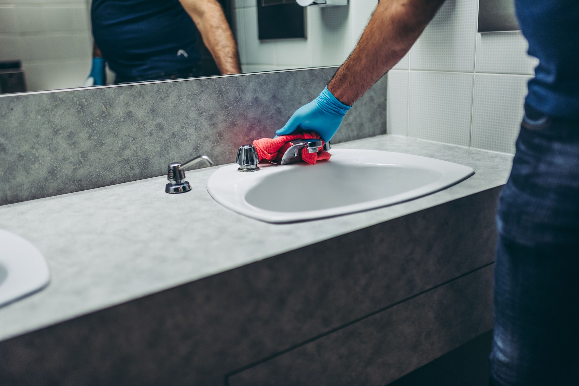 Janitor cleaning the bathroom.